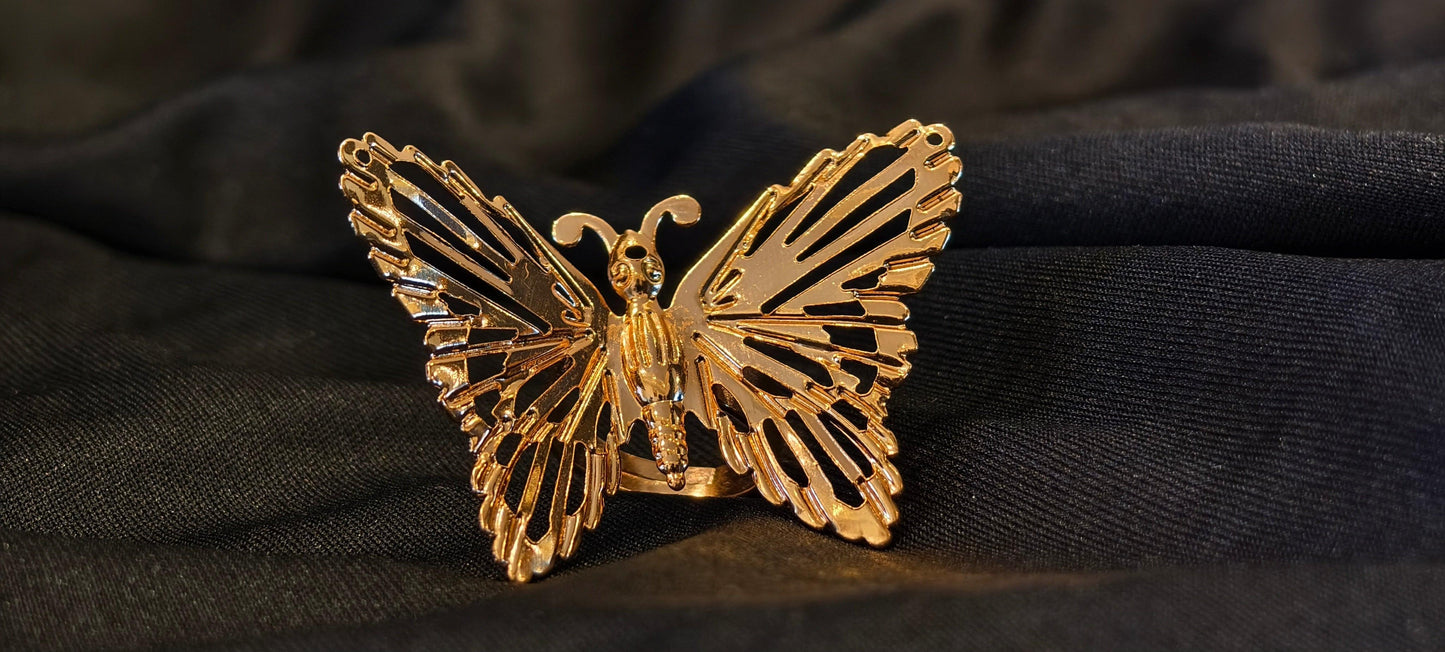 Fluttery gold ring symbolizing flirt and charm, perfect for elegant fashion statements.