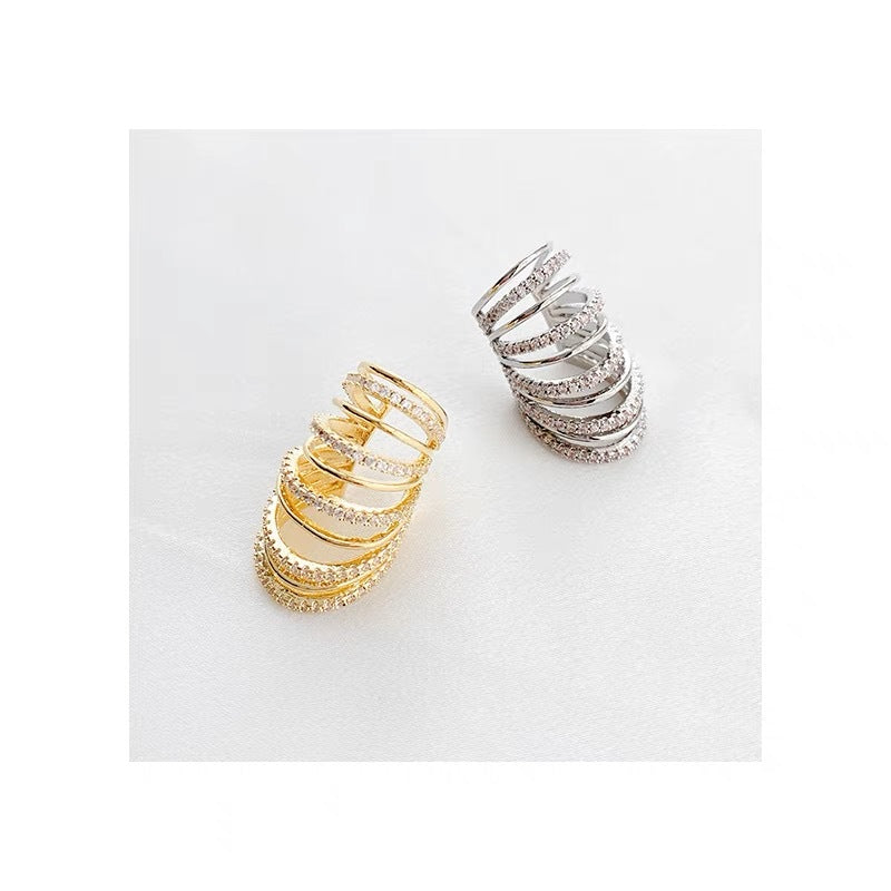 Gold spiral ear cuff with multiple adjustable bands, encrusted with imitation diamonds (CZ), designed for a bold statement look.