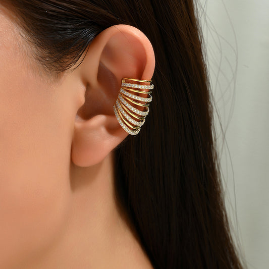 Gold spiral ear cuff with multiple adjustable bands, encrusted with imitation diamonds (CZ), designed for a bold statement look.
