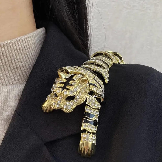 Gold panther brooch with gemstones on a dark blazer
